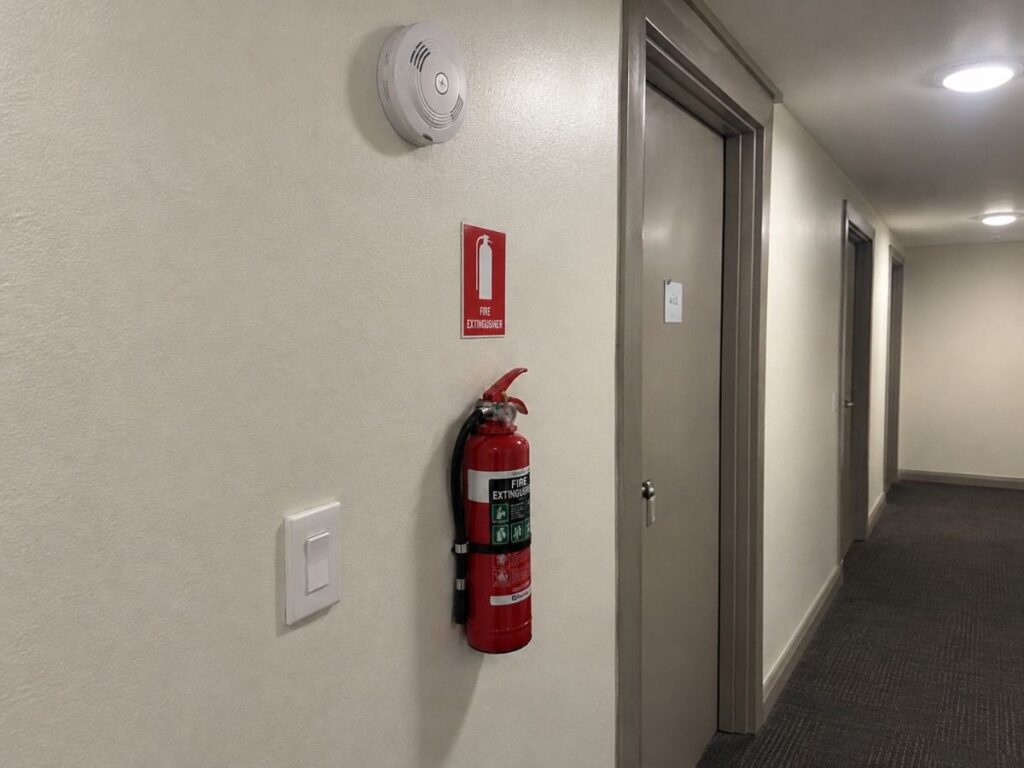 Smoke alarm and fire extinguisher in a Sydney short-stay property during an end of stay clean