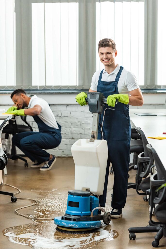 A cleaner operating a floor-cleaning machine