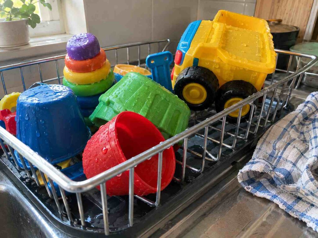 Childcare toys air-drying after washing, showing how to clean toys in childcare safely