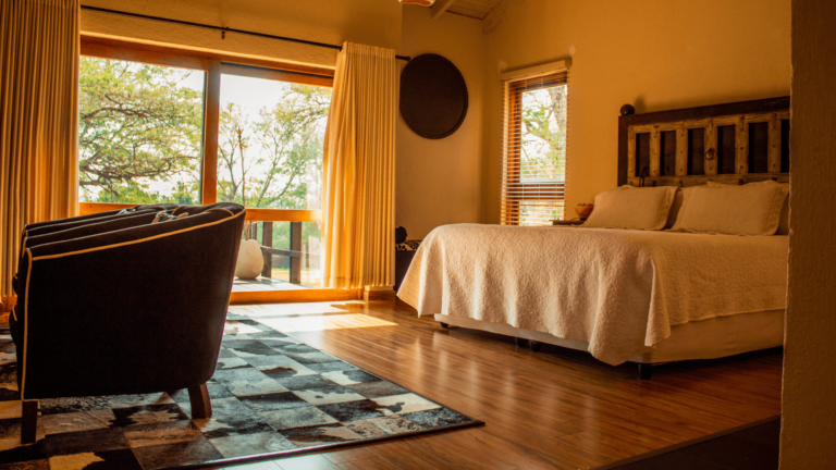 A cleaner polishing a window to leave the property guest-ready