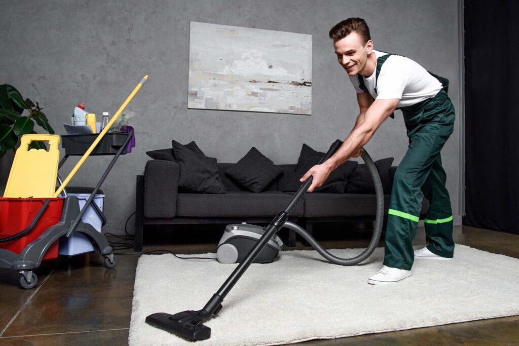 Top Sydney Cleaners team member vacuuming a living-room rug