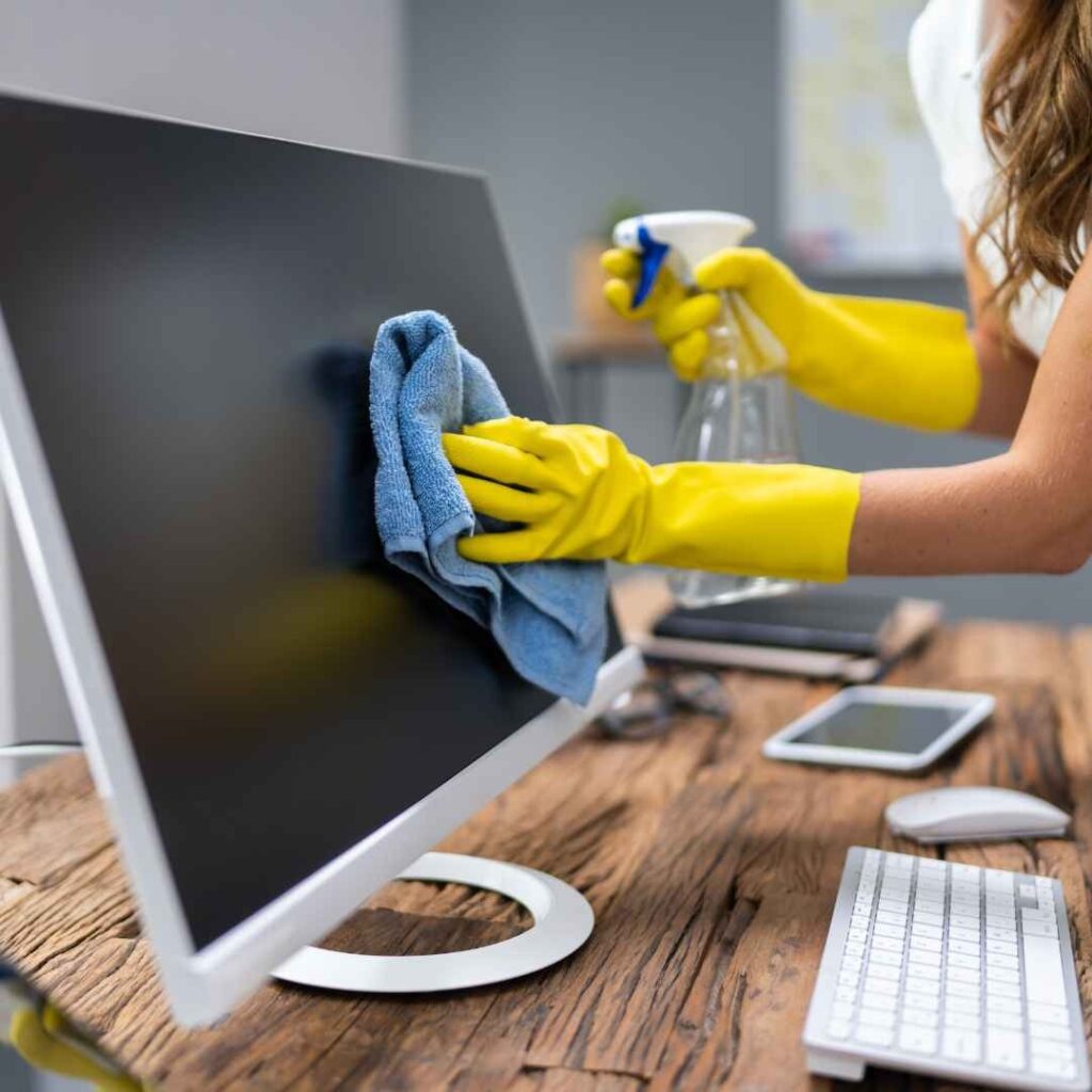 Tidy office desk and monitor after a commercial clean